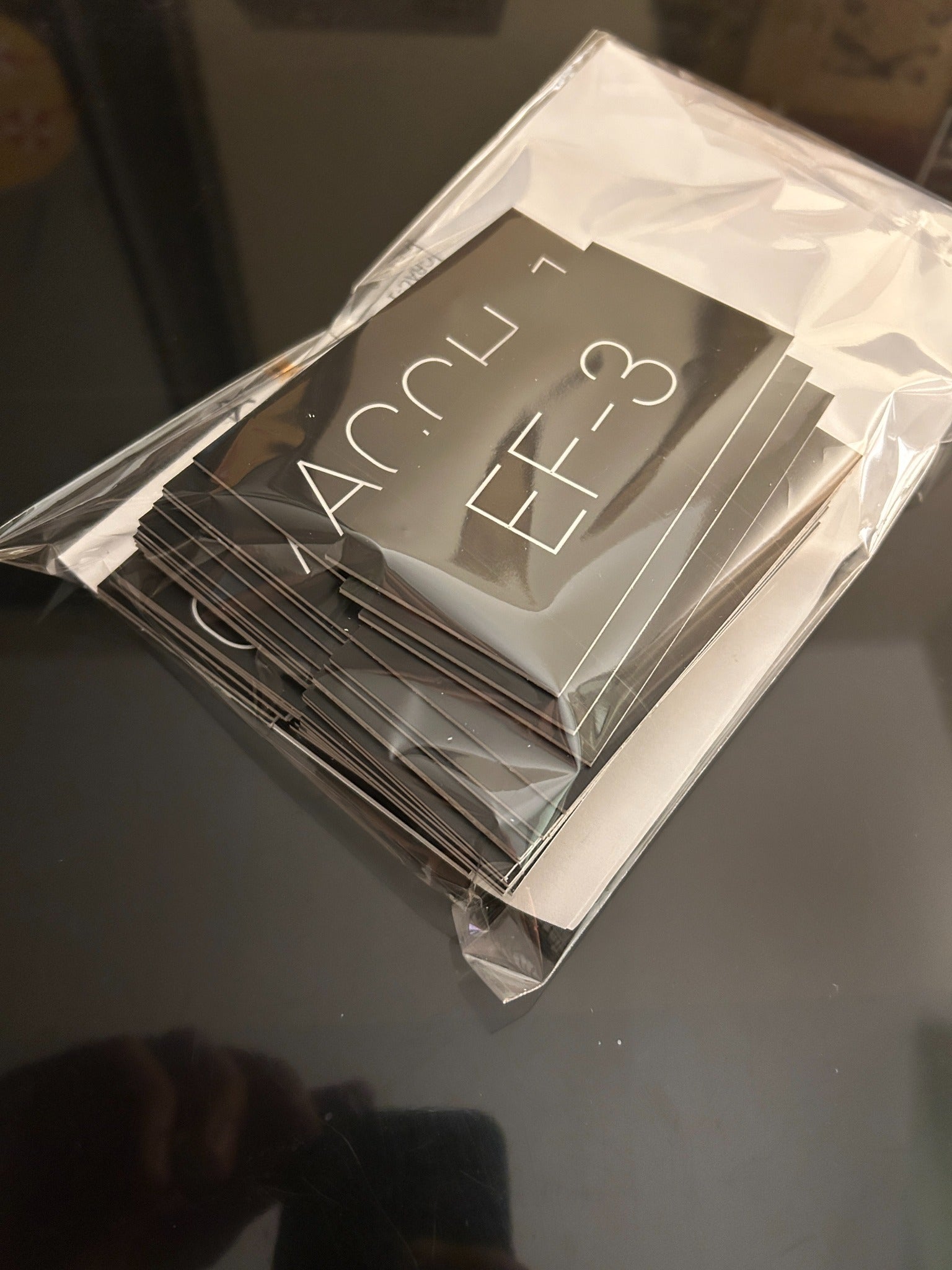 Packaged stack of engraved acrylic equipment labels